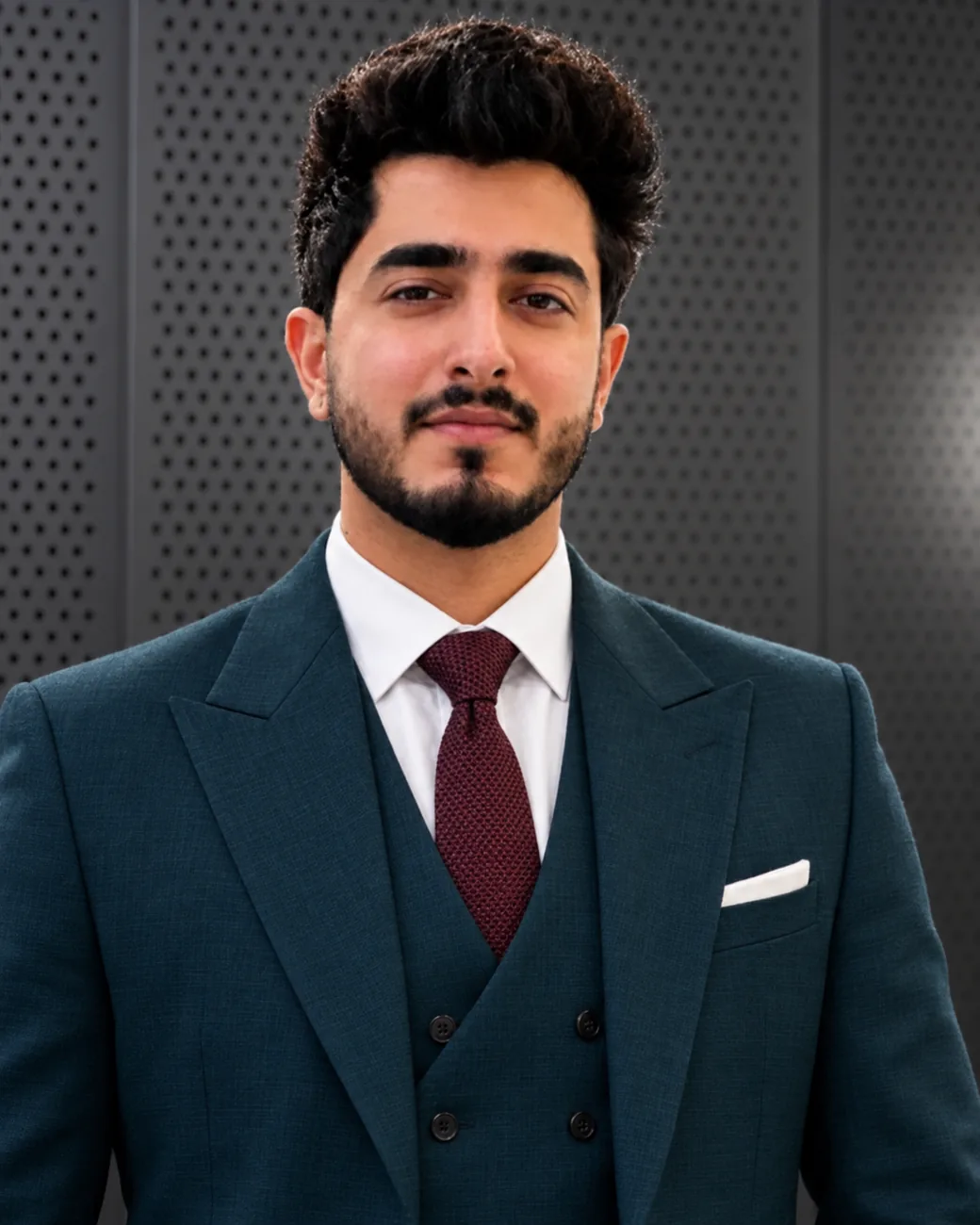 Rishabh Arora Rishabh Arora, a senior compliance officer, poses for a professional portrait in a teal suit and red tie.