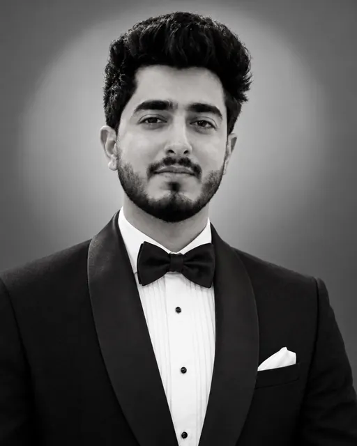 A man in a tuxedo poses for a formal black and white portrait of Rishabh Arora, a senior compliance officer.
